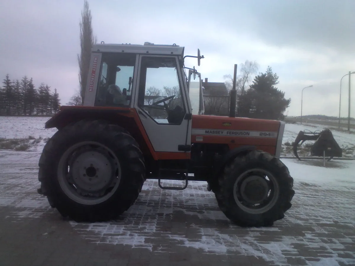 Massey Ferguson 294 von der Seite auf dem Hof, im Hintergrund Felder